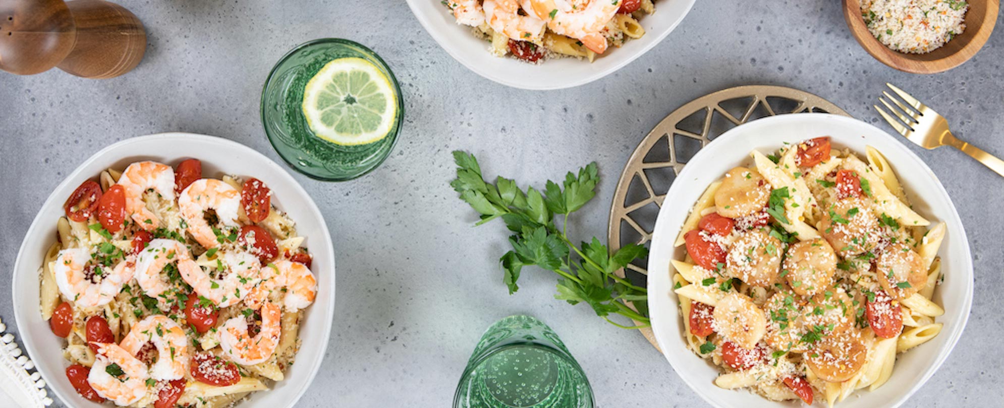 Home Chef meals in bowls with pasta, tomatoes, shrimp, sausage and cheese.