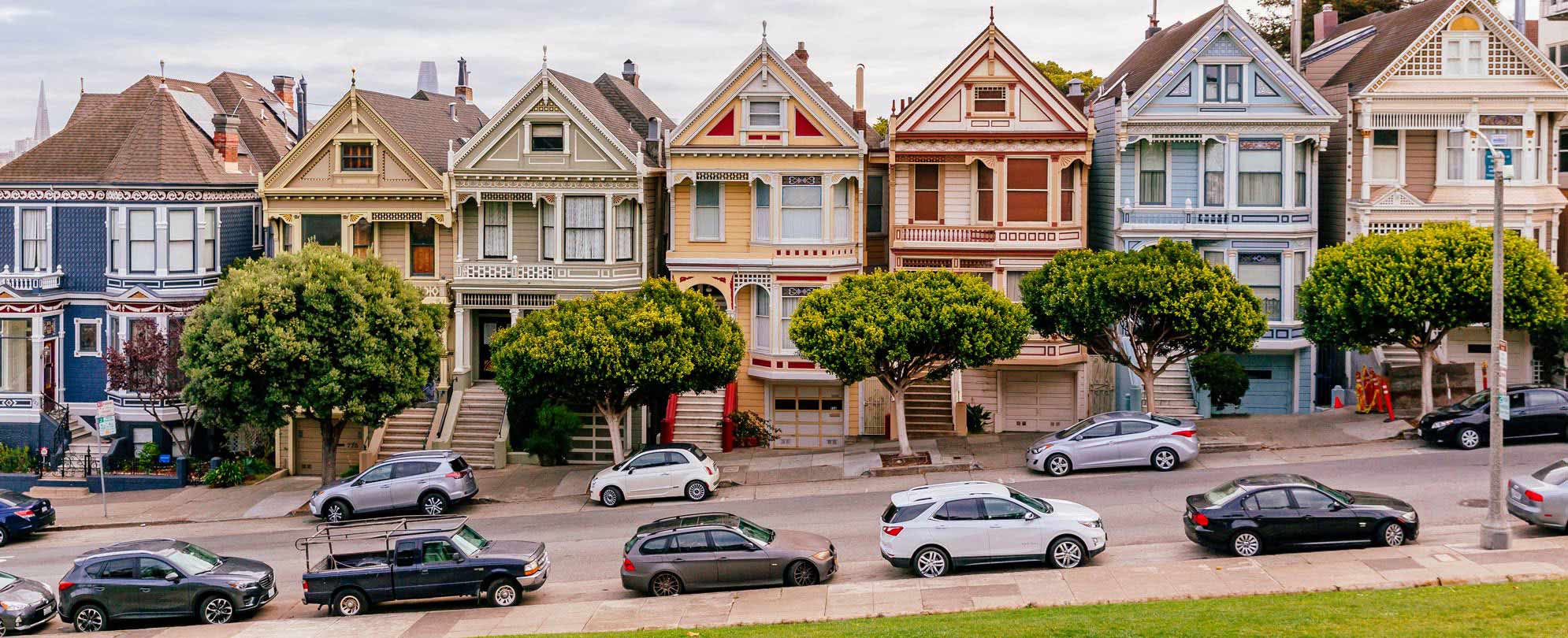 A row of ornate Victorian style houses on a residential street