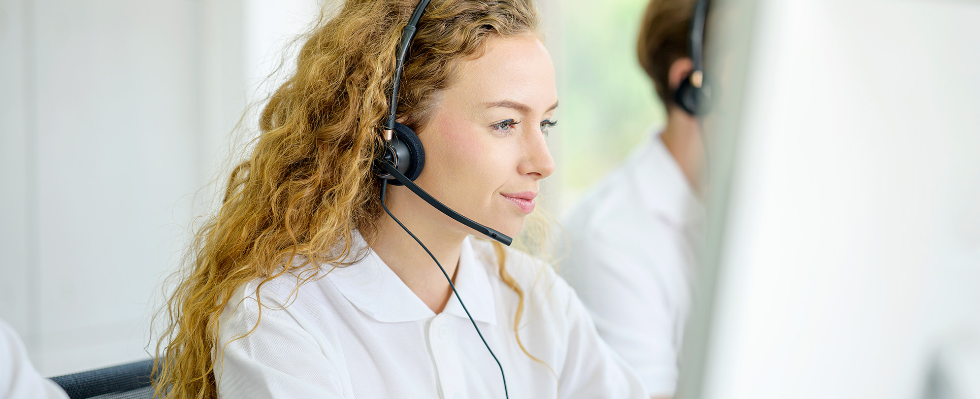 A Margaritaville Vacation Club representative wearing a headset working. 