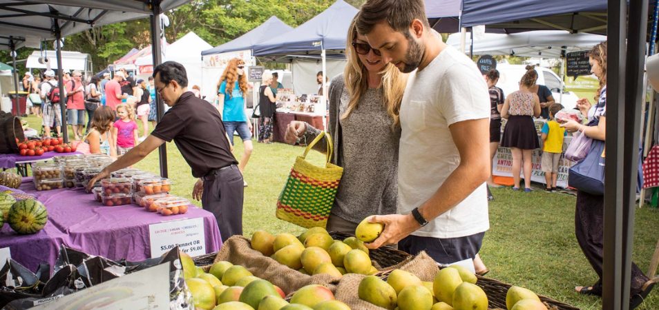 Man and woman shop for fruit at an ourdoor market in the Condado District, a lively neighborhood in Puerto Rico.