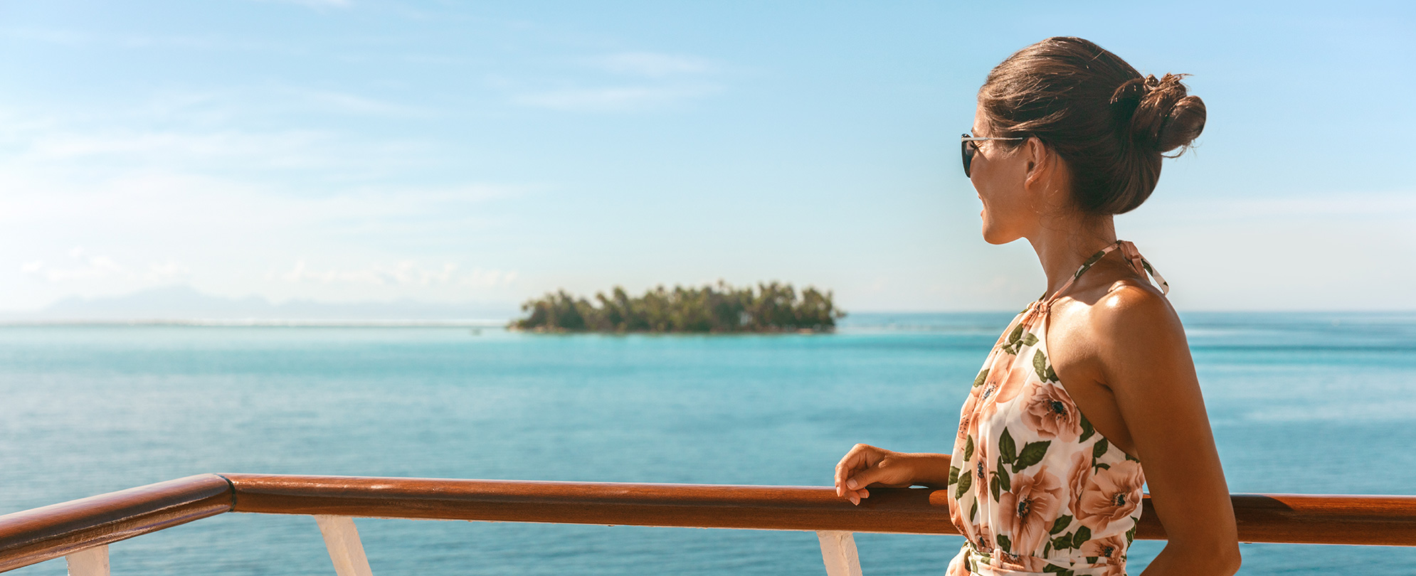 Cruise ship travel vacation luxury tourism woman looking at ocean from deck of sailing boat. Luxury Tahiti Bora Bora French Polynesia destination summer lifestyle.