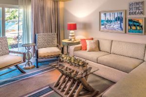 Tan couches in a living room of a Presidential Reserve suite at Margaritaville Vacation Club by Wyndham - St. Thomas.