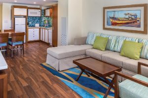 Living room, dining room, and kitchen in a Margaritaville Vacation Club by Wyndham - St. Thomas suite.