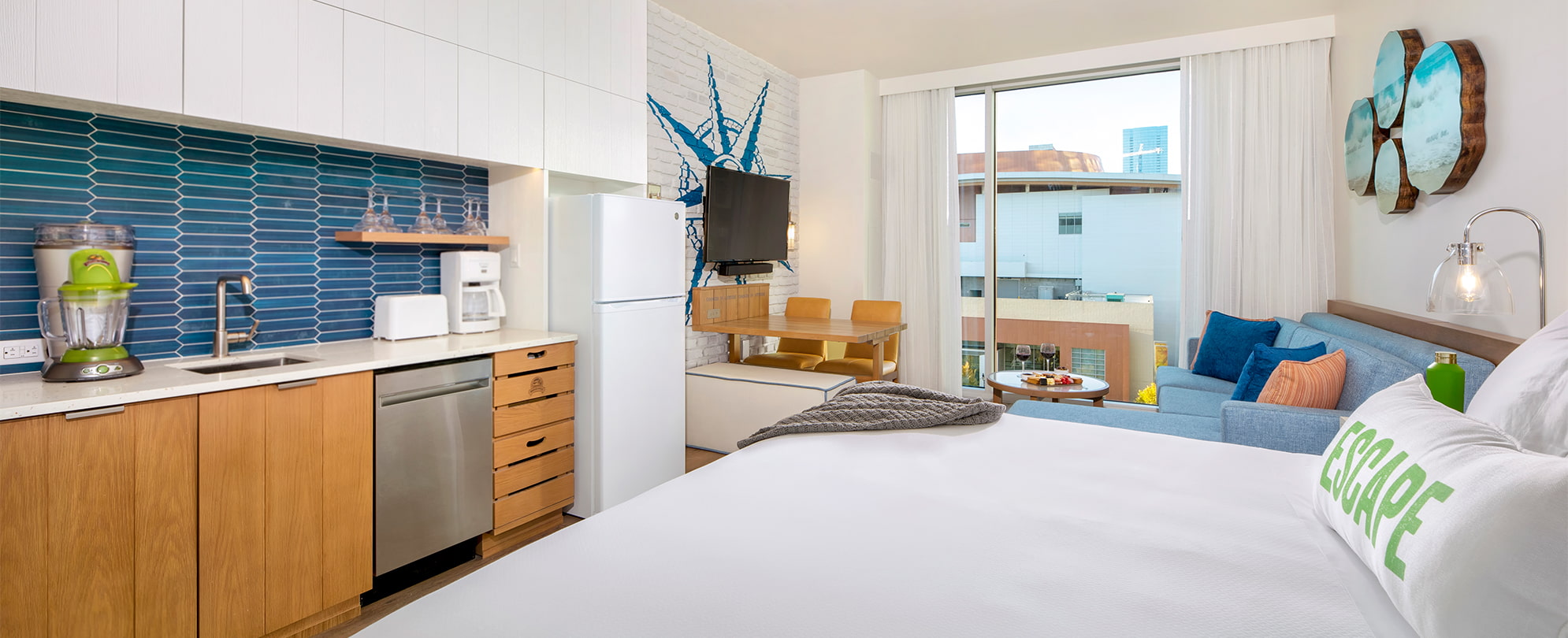 A full view of the bedroom, kitchen, and living area of a Margaritaville Vacation Club Studio suite at the Nashville, TN resort. 