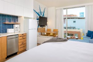 A full view of the bedroom, kitchen, and living area of a Margaritaville Vacation Club Studio suite at the Nashville, TN resort. 